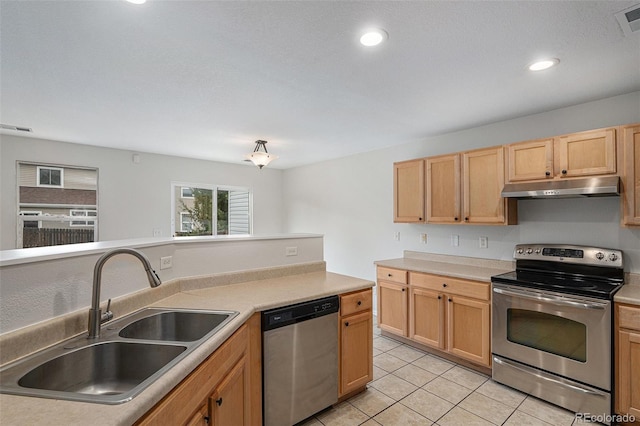 5531 S Quemoy Cir, Aurora, CO 80015 - kitchen featuring appliances with stainless steel finishes, under cabinet range hood, light tile patterned floors, light countertops, and light brown cabinets