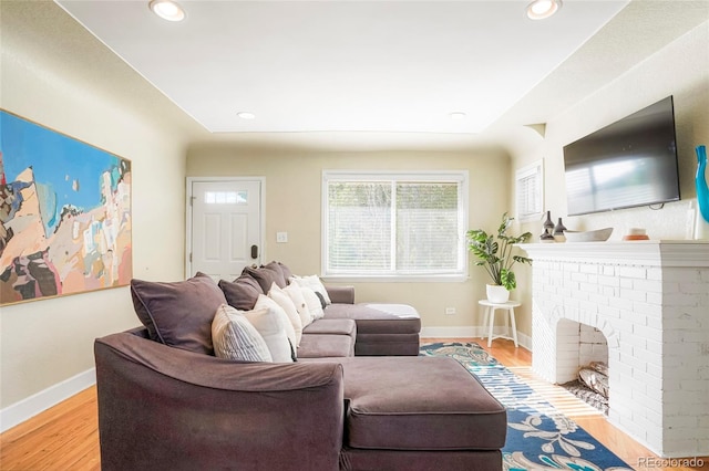 living room featuring a fireplace and light hardwood / wood-style floors