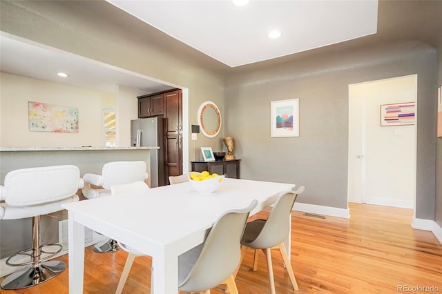 dining room with light hardwood / wood-style flooring