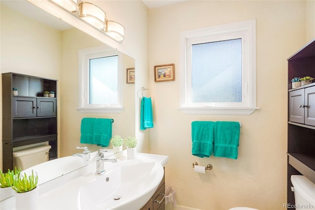 bathroom featuring vanity and toilet