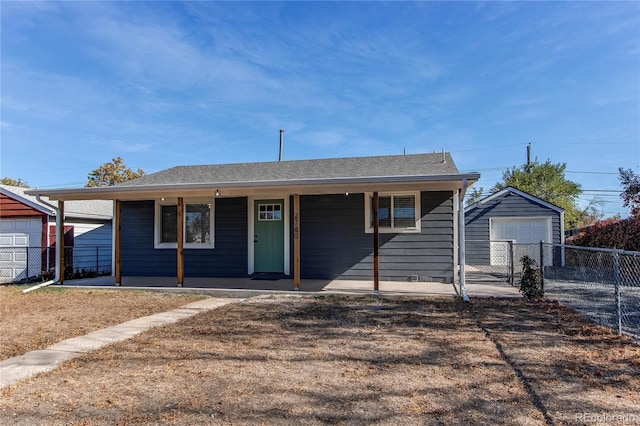 view of front facade with a porch, an outbuilding, and a garage