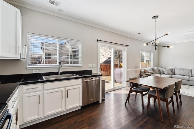 kitchen featuring pendant lighting, white cabinetry, stainless steel appliances, and sink