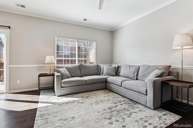 living room with hardwood / wood-style flooring and ornamental molding