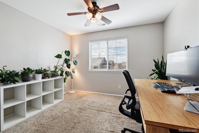 carpeted office space featuring ceiling fan