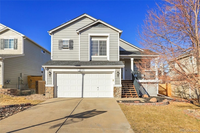 view of front of home featuring an attached garage, stone siding, driveway, and stairs