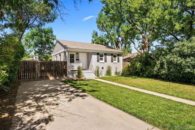 bungalow-style house with a porch, a front yard, and fence