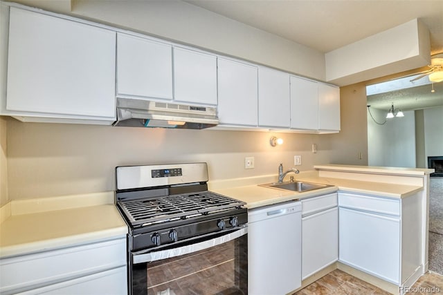 kitchen featuring dishwasher, ceiling fan with notable chandelier, sink, gas stove, and white cabinetry