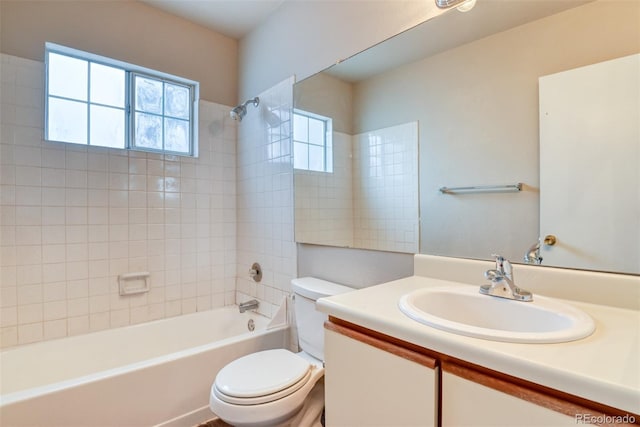 full bathroom featuring vanity, toilet, and tiled shower / bath