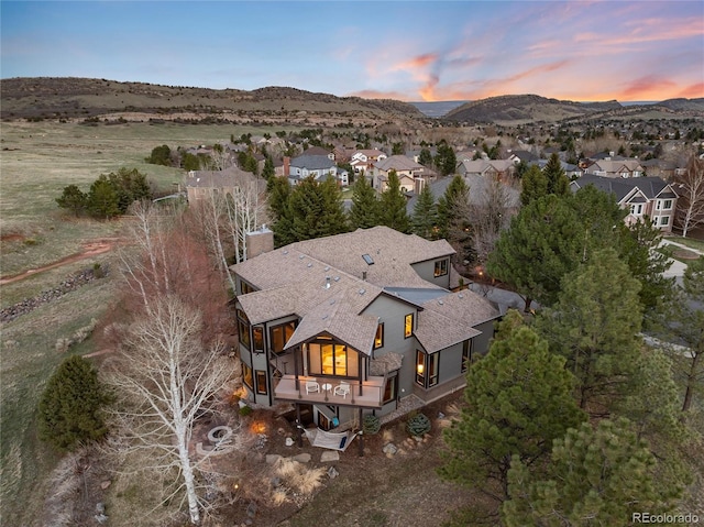 aerial view at dusk with a mountain view and a residential view
