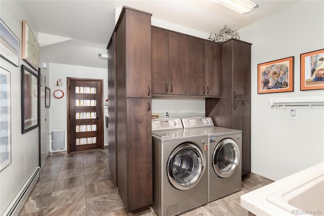 laundry room with baseboards, a baseboard heating unit, washing machine and clothes dryer, and cabinet space