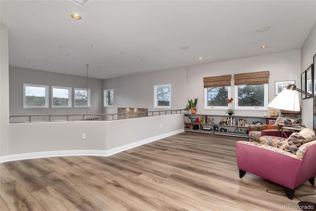 interior space with wood finished floors, baseboards, and recessed lighting
