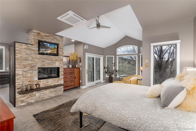 bedroom with a ceiling fan, a fireplace, vaulted ceiling, access to exterior, and carpet flooring