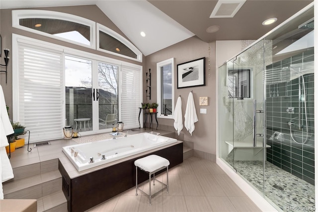 bathroom with tile patterned flooring, a garden tub, vaulted ceiling, and a stall shower