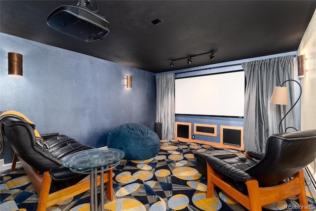 home theater room featuring track lighting