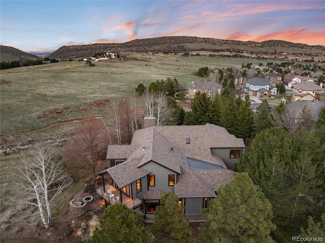 aerial view at dusk featuring a mountain view