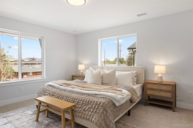 bedroom featuring light carpet, baseboards, and visible vents