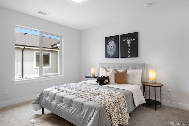 bedroom featuring baseboards, visible vents, and carpet