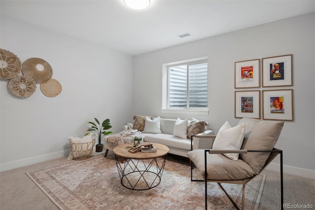 carpeted living room featuring baseboards and visible vents