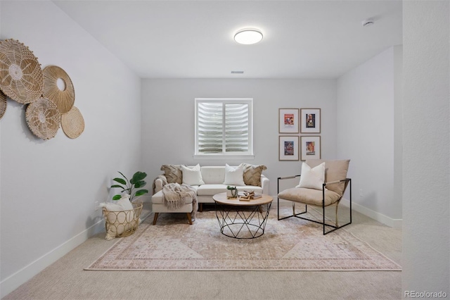 sitting room featuring baseboards and carpet floors