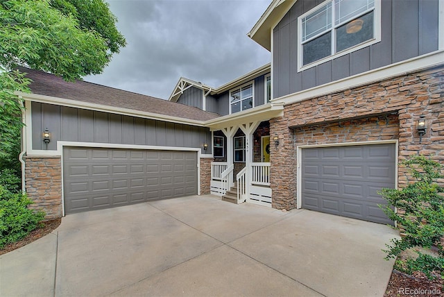 1839 Caleta Trl, Longmont, CO 80504 - view of front of house featuring stone siding, board and batten siding, driveway, and roof with shingles