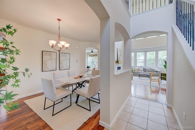 1839 Caleta Trl, Longmont, CO 80504 - dining space with arched walkways, plenty of natural light, a chandelier, and light wood-style floors