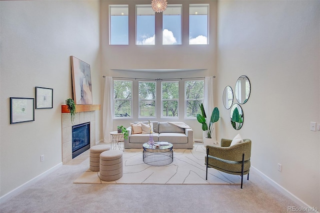 1839 Caleta Trl, Longmont, CO 80504 - carpeted living area with a tiled fireplace and a towering ceiling