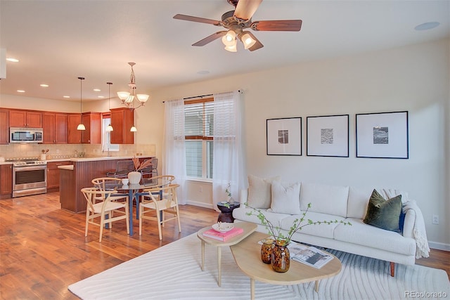 1839 Caleta Trl, Longmont, CO 80504 - living area featuring light wood-type flooring, a ceiling fan, and recessed lighting