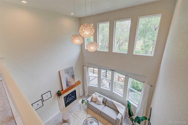 1839 Caleta Trl, Longmont, CO 80504 - living area with plenty of natural light, a high ceiling, a fireplace, a chandelier, and recessed lighting