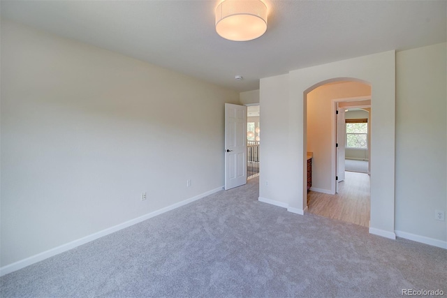 1839 Caleta Trl, Longmont, CO 80504 - unfurnished bedroom featuring arched walkways and carpet flooring
