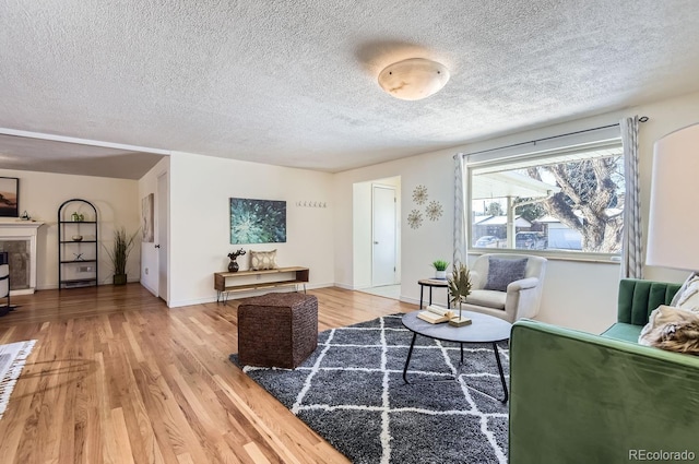 living room featuring hardwood / wood-style flooring and a textured ceiling