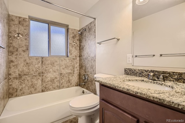 full bathroom with vanity, tiled shower / bath, and toilet