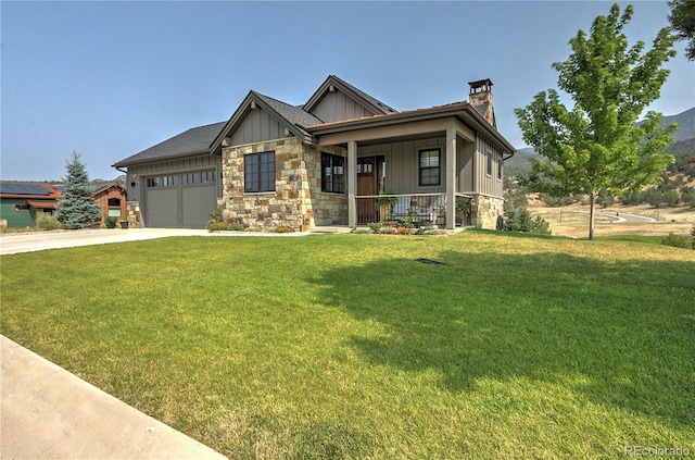 craftsman inspired home with a garage, covered porch, and a front lawn