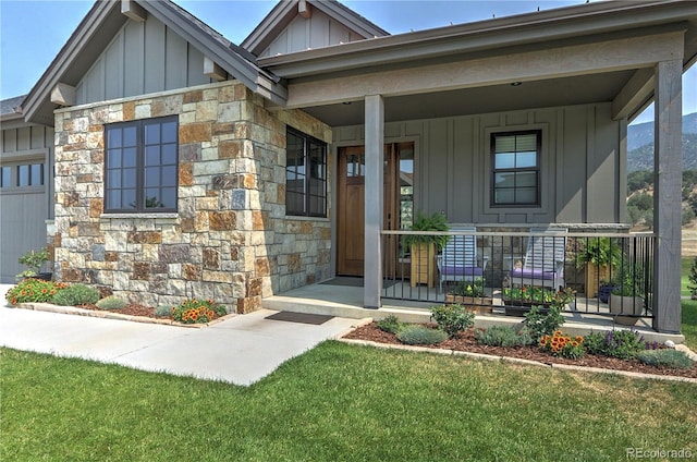 entrance to property featuring a porch and a lawn