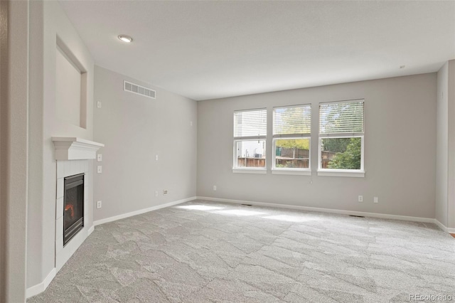 unfurnished living room with light colored carpet