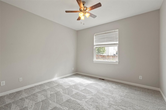 carpeted empty room featuring ceiling fan