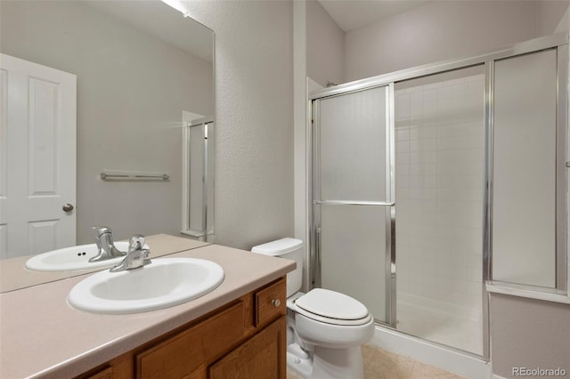 bathroom with tile patterned flooring, vanity, toilet, and a shower with door