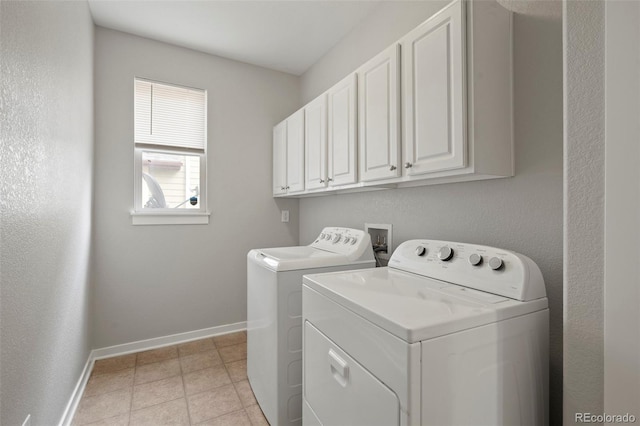 laundry room with cabinets and washer and dryer