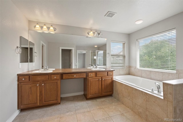 bathroom with shower with separate bathtub, vanity, and tile patterned floors