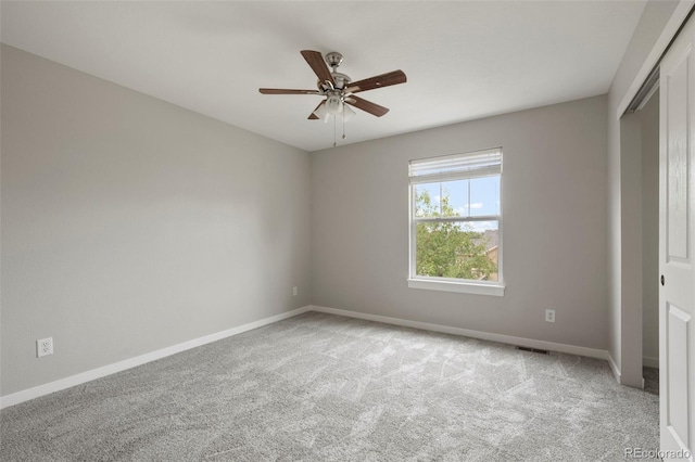 unfurnished bedroom featuring ceiling fan, light colored carpet, and a closet