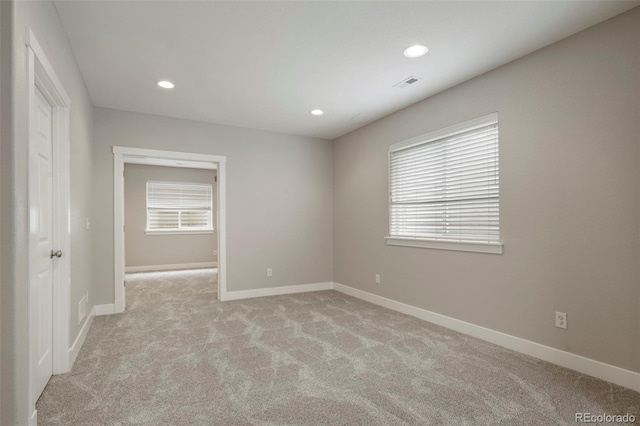 unfurnished room with light carpet