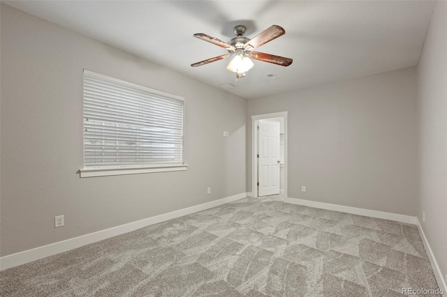 carpeted spare room featuring ceiling fan