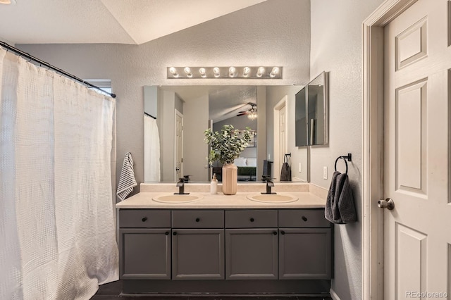 4567 Flanders Way, Denver, CO 80249 - full bath featuring lofted ceiling, a textured wall, double vanity, a ceiling fan, and curtained shower