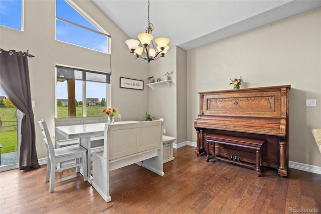 8101 Wynstone Dr, Windsor, CO 80550 - dining area featuring a chandelier, plenty of natural light, wood finished floors, high vaulted ceiling, and baseboards