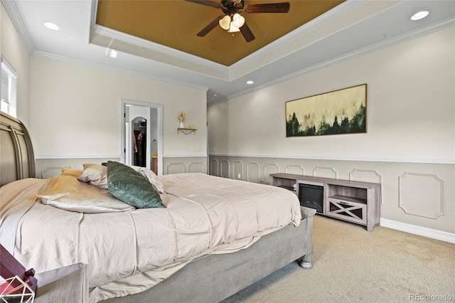 8101 Wynstone Dr, Windsor, CO 80550 - bedroom with ornamental molding, a raised ceiling, carpet, a walk in closet, and wainscoting