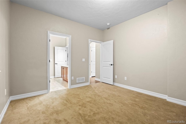 8101 Wynstone Dr, Windsor, CO 80550 - unfurnished bedroom featuring light carpet, baseboards, and ensuite bathroom