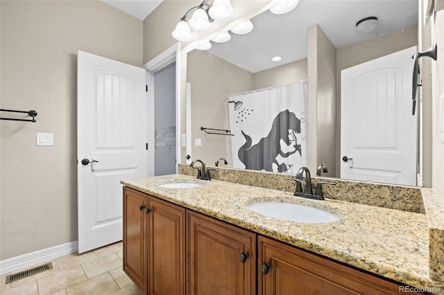 8101 Wynstone Dr, Windsor, CO 80550 - bathroom featuring double vanity and baseboards