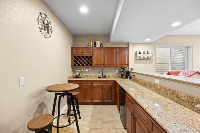 8101 Wynstone Dr, Windsor, CO 80550 - kitchen with dishwasher, a sink, light stone counters, brown cabinetry, and recessed lighting