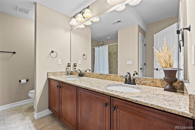 8101 Wynstone Dr, Windsor, CO 80550 - bathroom featuring toilet, double vanity, baseboards, and curtained shower