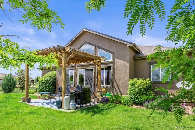 8101 Wynstone Dr, Windsor, CO 80550 - back of property featuring a pergola, stucco siding, a patio area, and a lawn