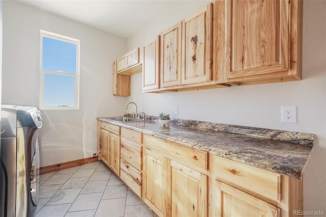 kitchen featuring light brown cabinets, sink, and washer / clothes dryer